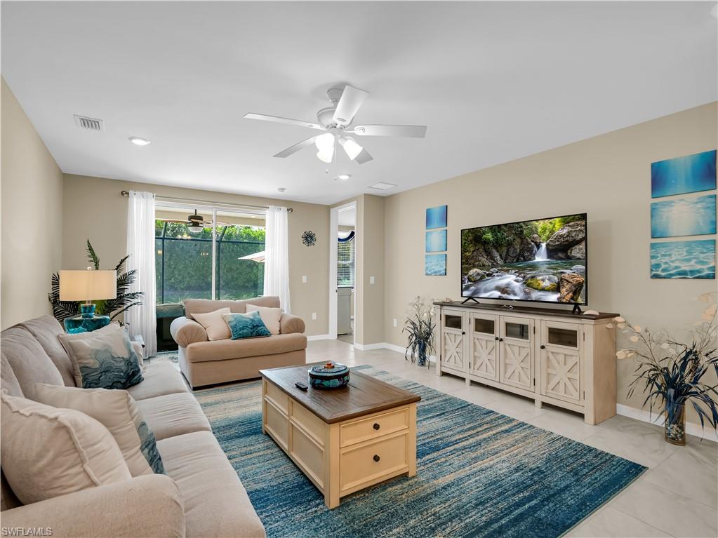 14695 Edgewater Circle Naples, FL 34114 - Photo 17 of 39 a living room with furniture and a flat screen tv