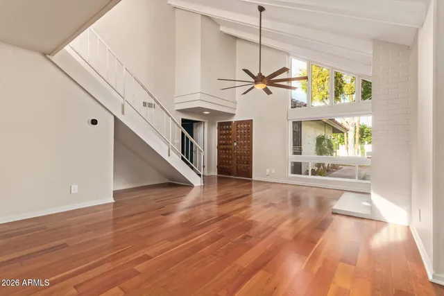 a view of an entryway with wooden floor and door