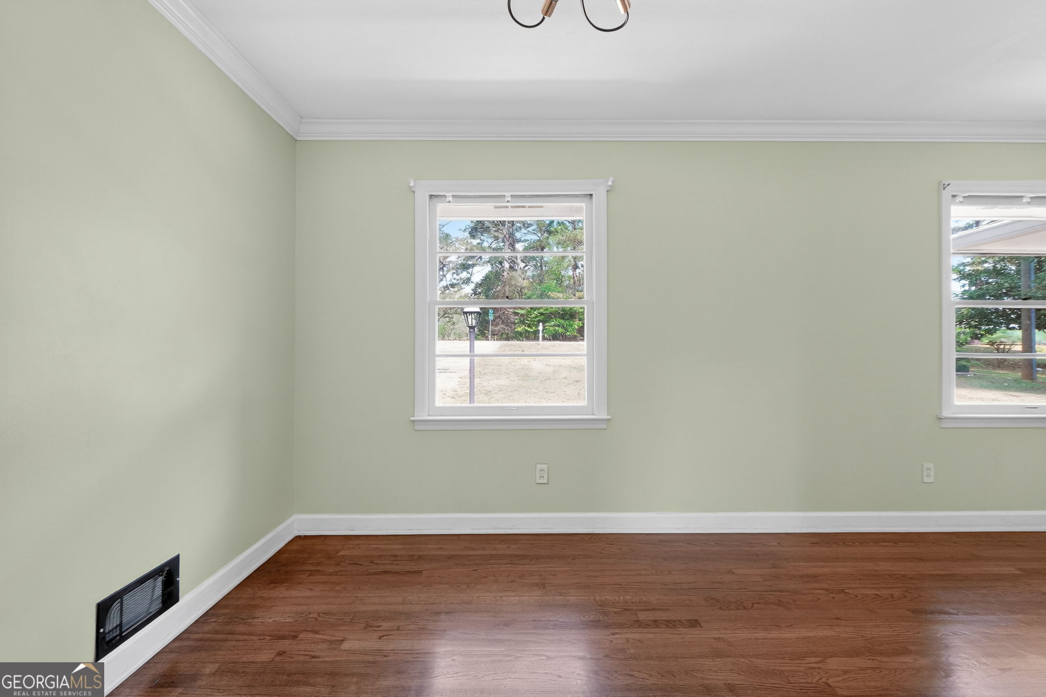 3825 Highway 81 Hampton, GA 30228 - Photo 12 of 25 an empty room with wooden floor and windows