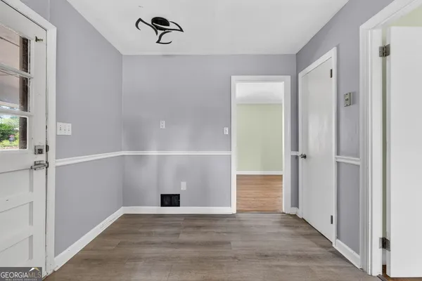 a view of an empty room with closet and windows