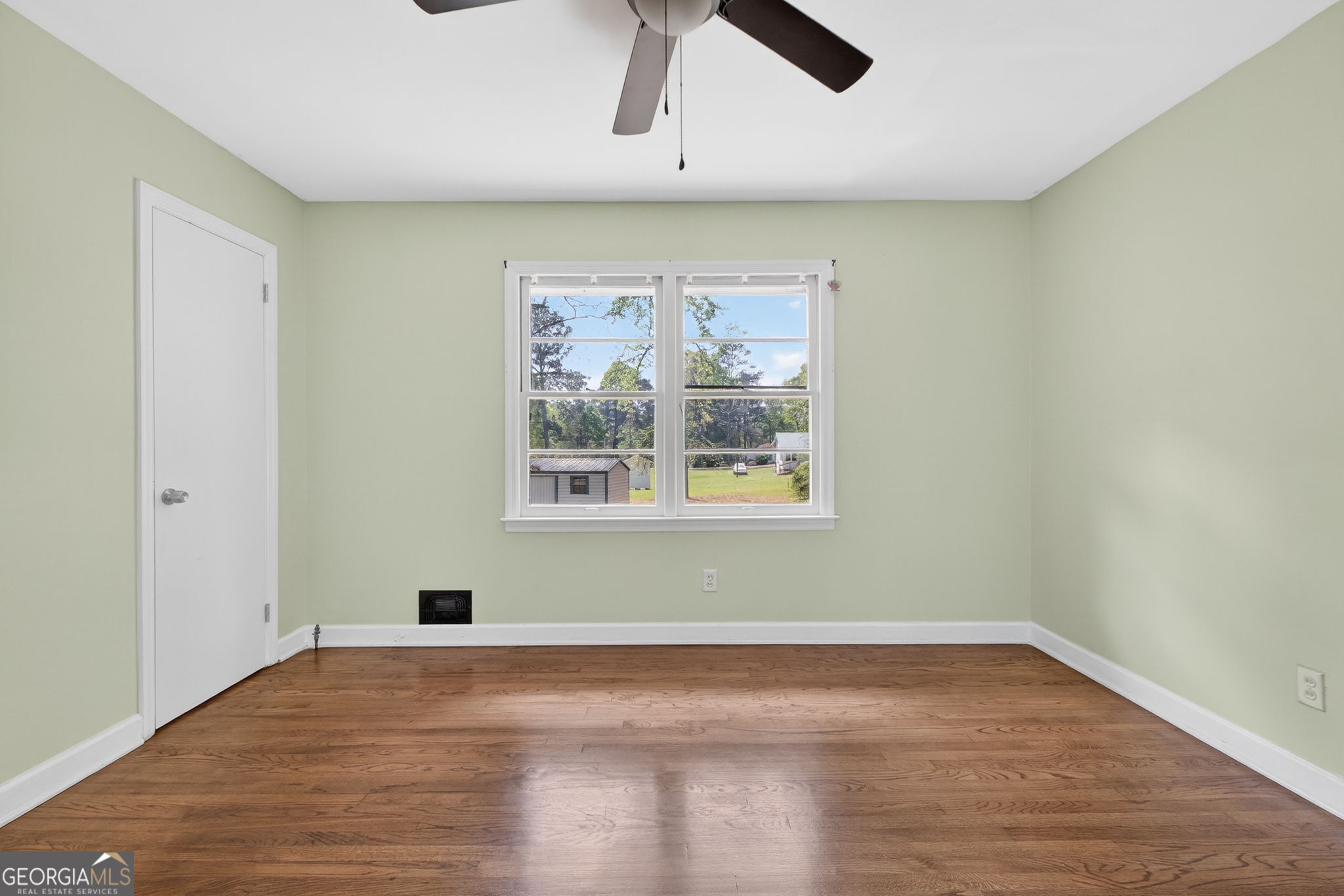 3825 Highway 81 Hampton, GA 30228 - Photo 16 of 25 an empty room with wooden floor and windows