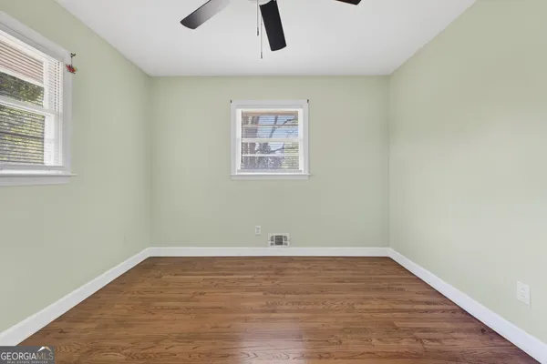 wooden floor in an empty room with a window