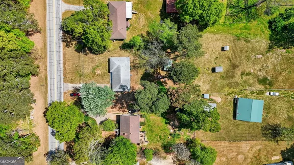 an aerial view of residential houses with outdoor space and street view