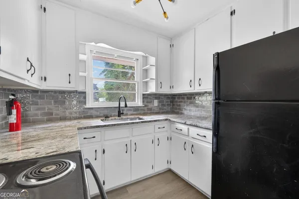a kitchen with a sink stove and cabinets