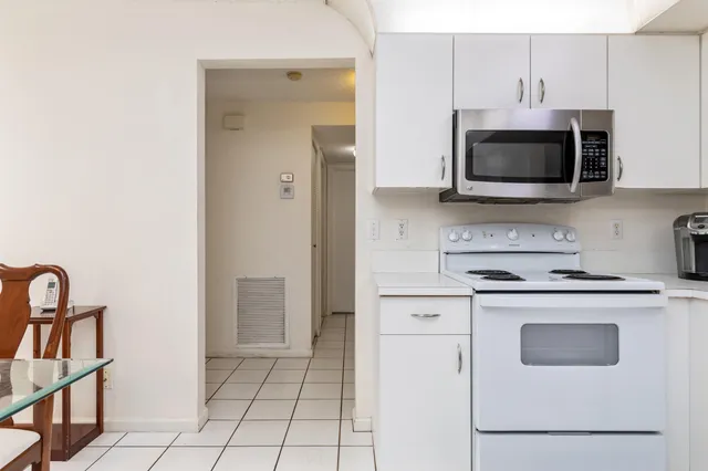 a kitchen with cabinets stainless steel appliances and a counter space