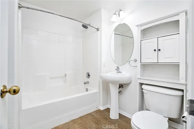 a bedroom with a bed and a potted plant