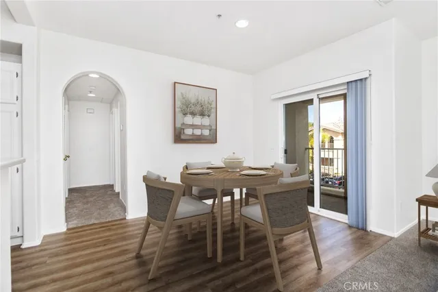a view of a dining room with furniture and a potted plant