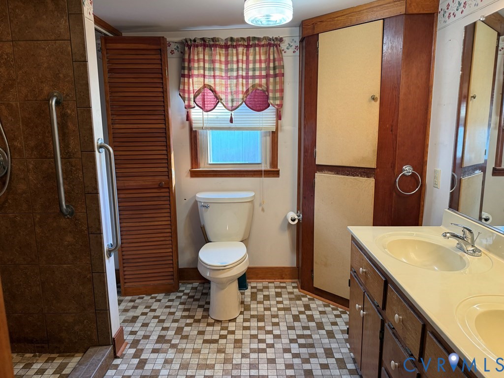 243 Tuggle Road Prospect, VA 23960 - Photo 21 of 24 a bathroom with a sink a toilet and mirror