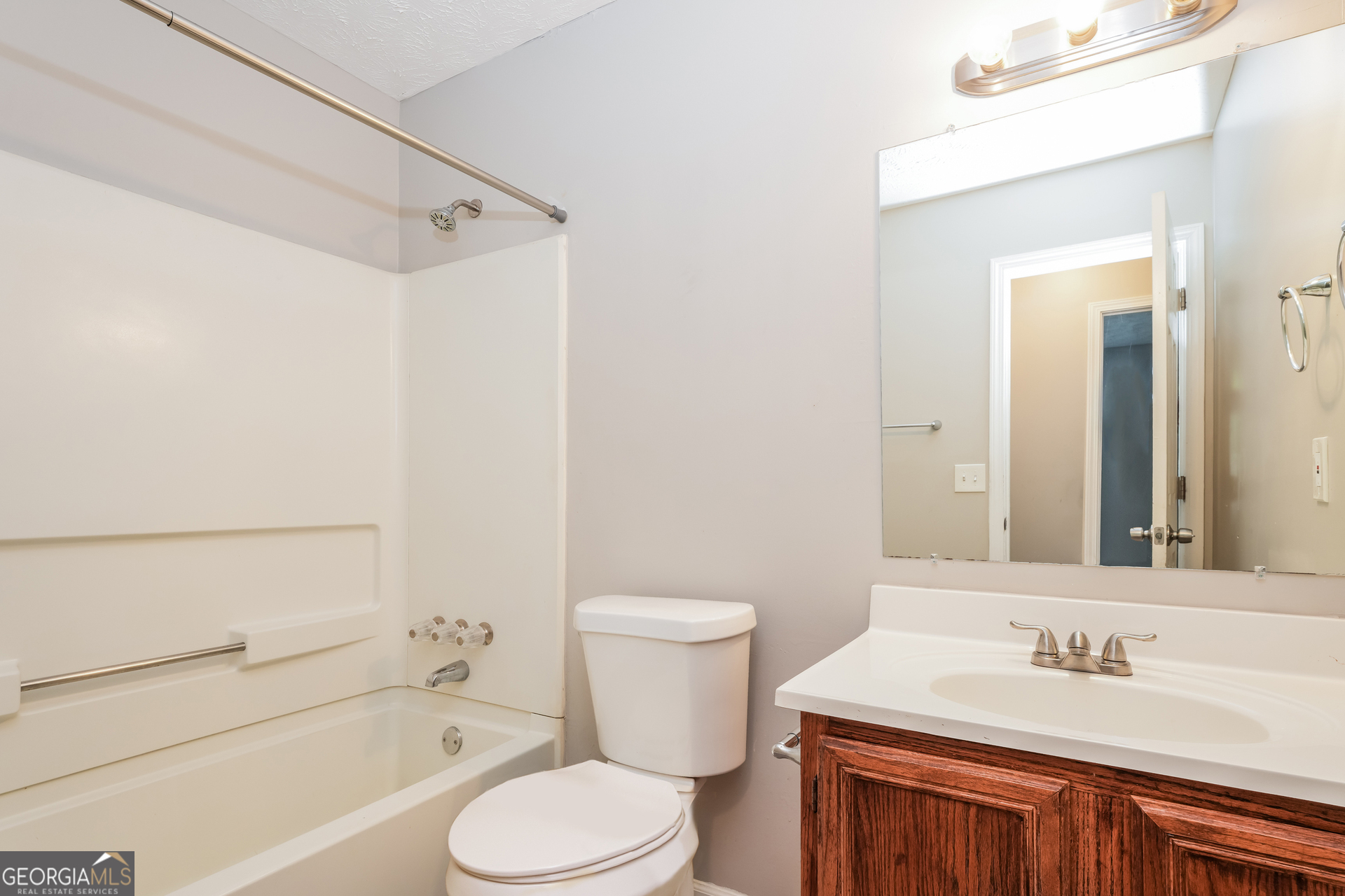 5591 Sapphire Spring Stone Mountain, GA 30088 - Photo 13 of 17 a bathroom with a sink toilet vanity and shower