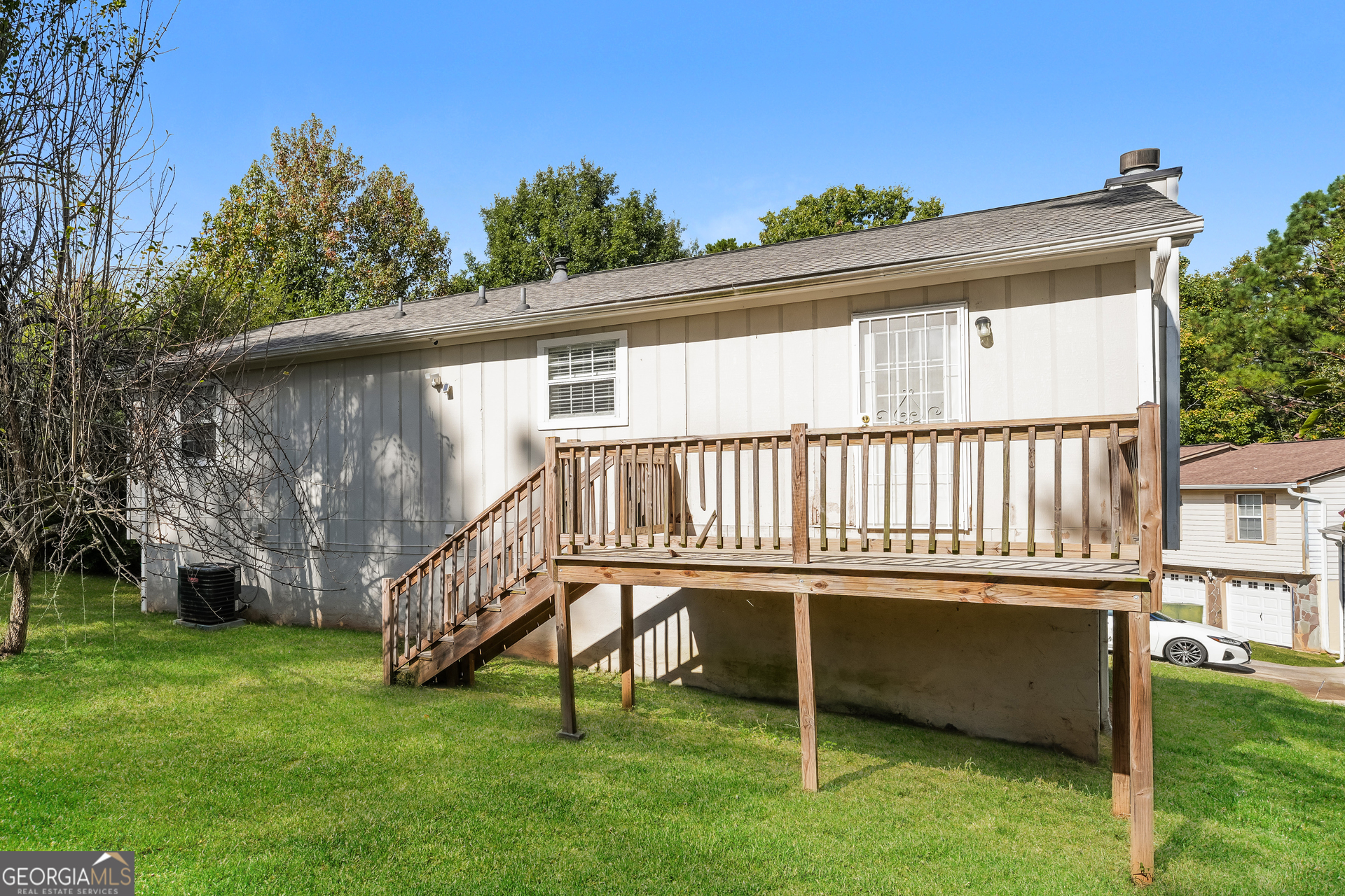 5591 Sapphire Spring Stone Mountain, GA 30088 - Photo 14 of 17 a backyard of a house with a garden and deck
