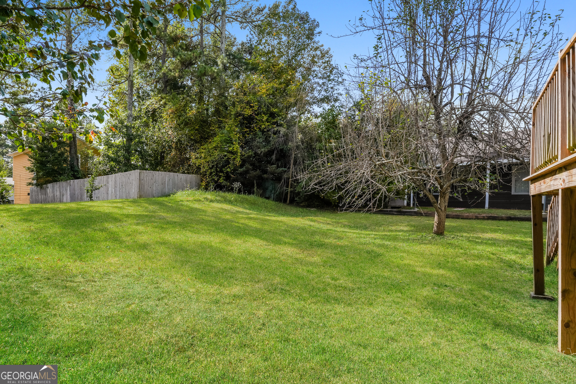 5591 Sapphire Spring Stone Mountain, GA 30088 - Photo 15 of 17 a view of a field with tree in front of it