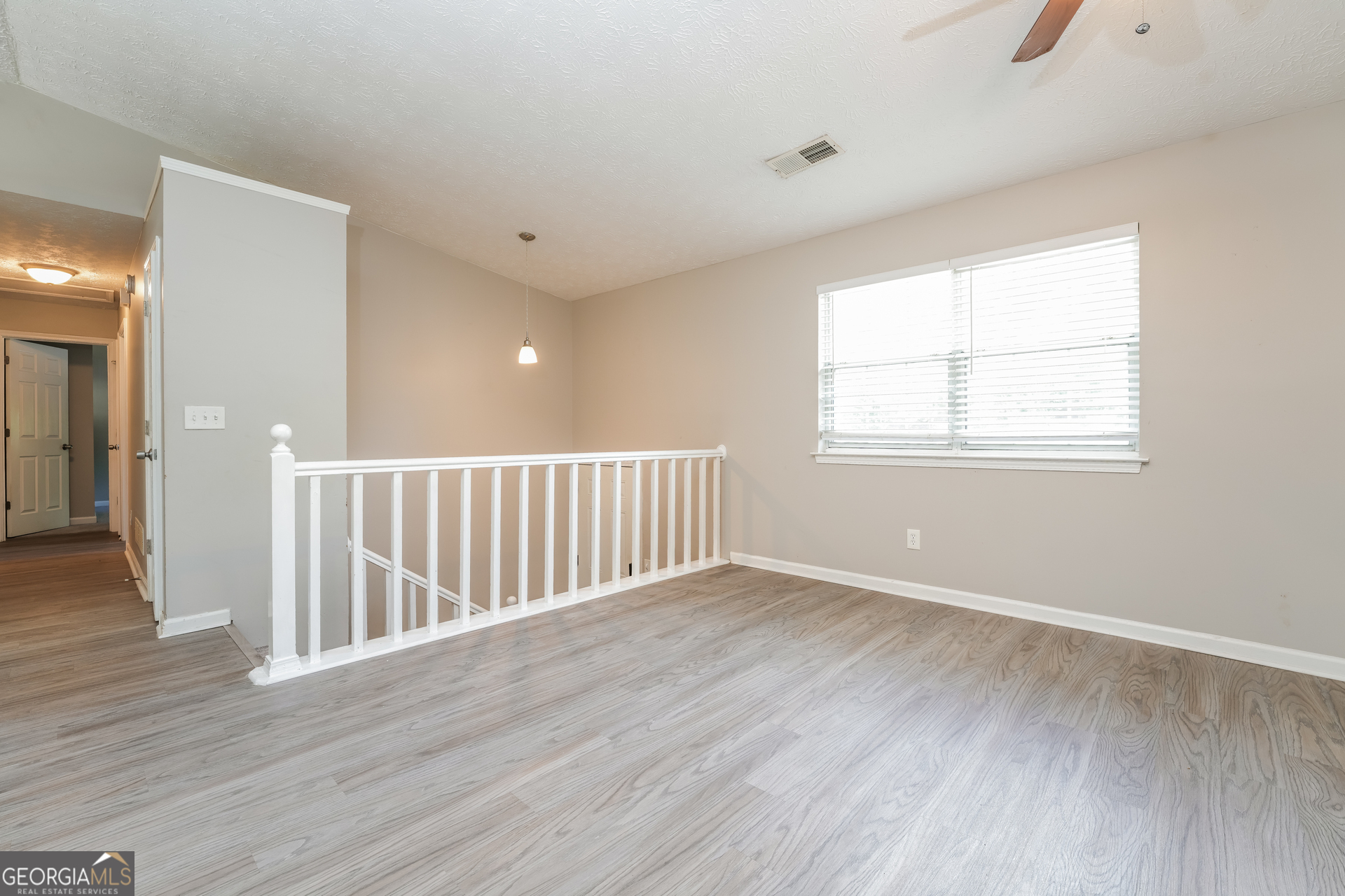 5591 Sapphire Spring Stone Mountain, GA 30088 - Photo 2 of 17 a view of an empty room with wooden floor and a window