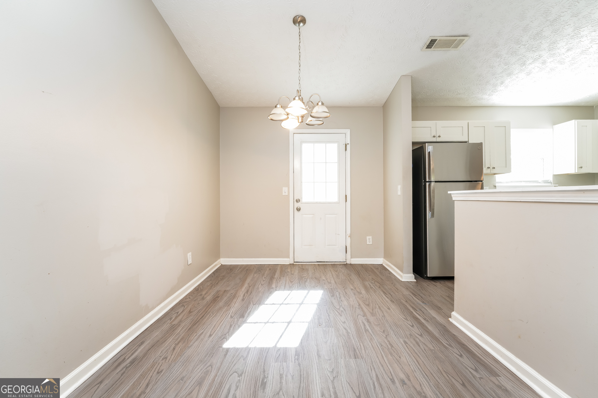 5591 Sapphire Spring Stone Mountain, GA 30088 - Photo 4 of 17 a view of a room with wooden floor and windows