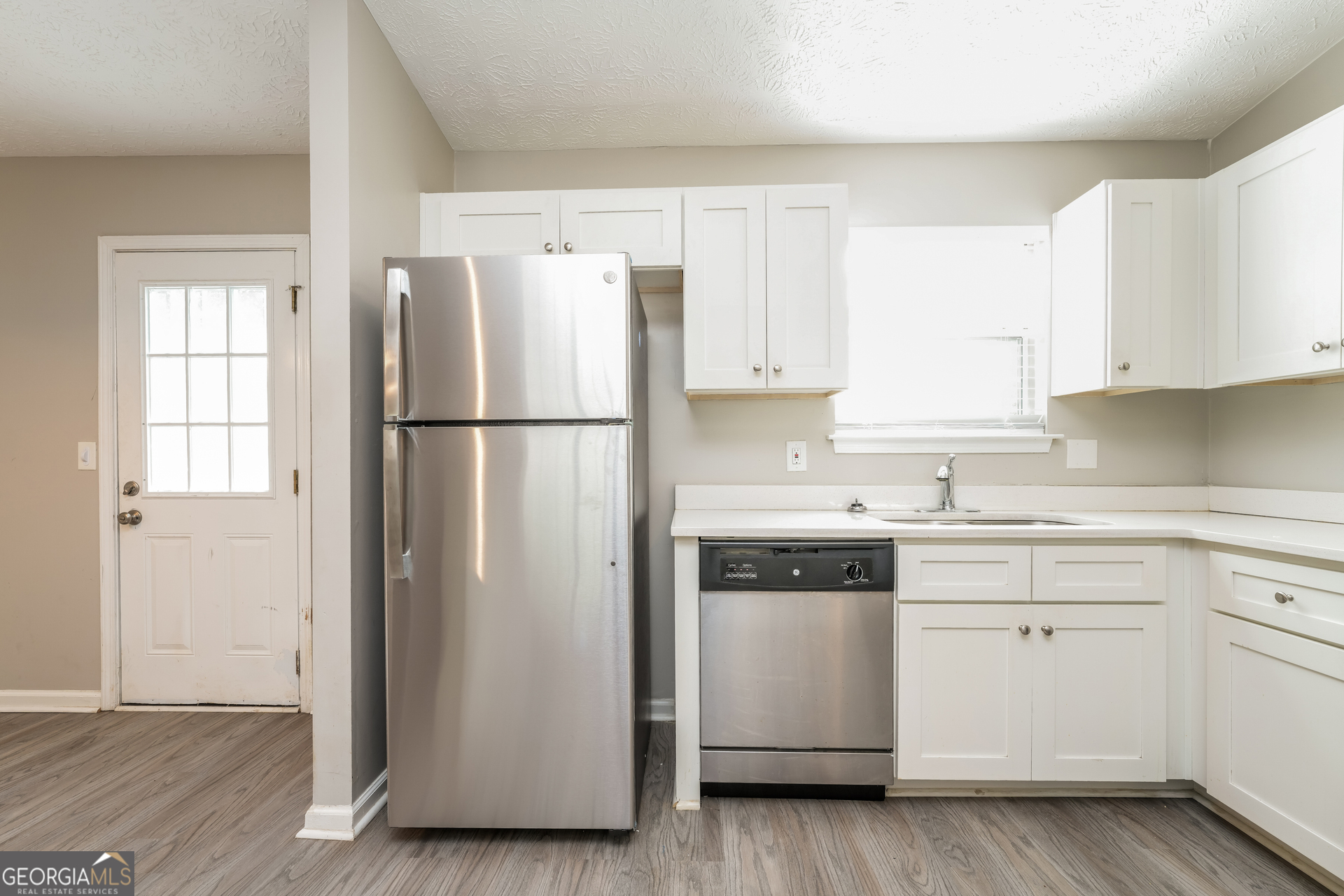 5591 Sapphire Spring Stone Mountain, GA 30088 - Photo 5 of 17 a kitchen with a refrigerator sink stove and cabinets