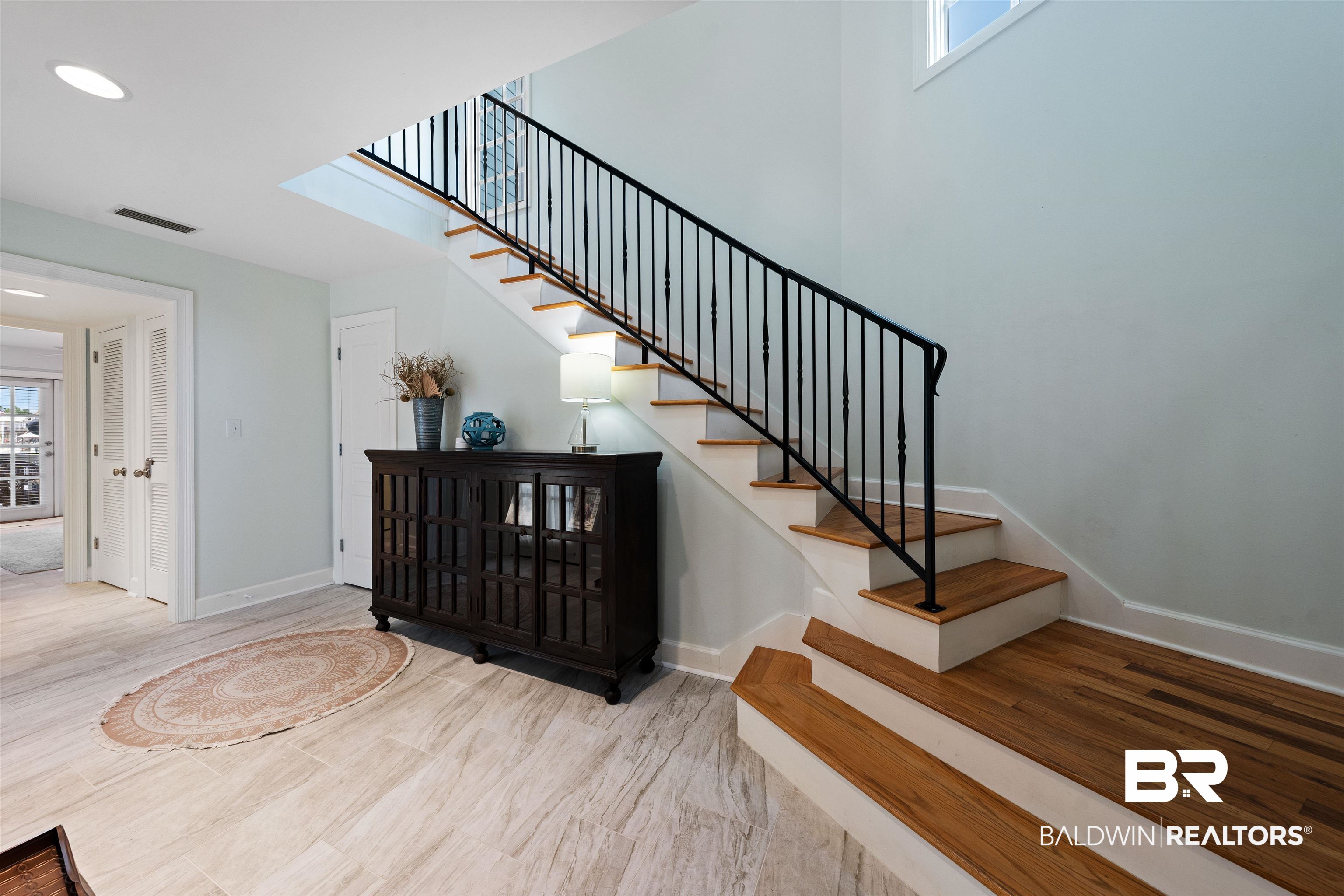 3434 Mariner Circle Orange Beach, AL 36561 - Photo 12 of 38 Stairway featuring light hardwood / wood-style floors and tile.