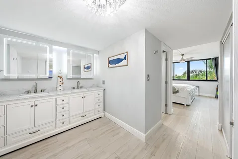 a spacious bathroom with a granite countertop sink a mirror a vanity and a