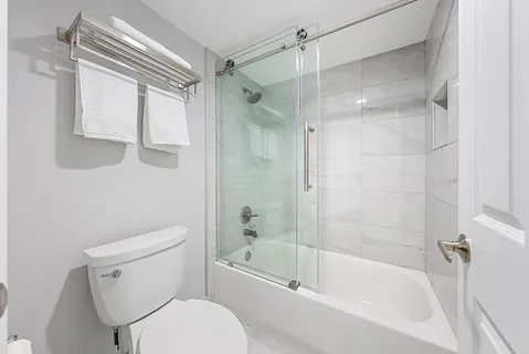 a living room with furniture potted plant and a large window