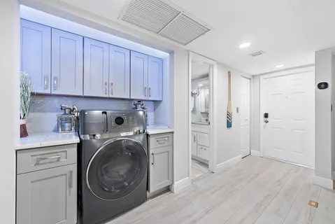 a living room with patio furniture and a floor to ceiling window