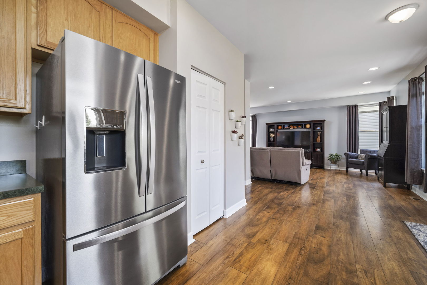 3815 Cherry Tree Lane Joliet, IL 60435 - Photo 11 of 37 a kitchen with stainless steel appliances a refrigerator and wooden floor