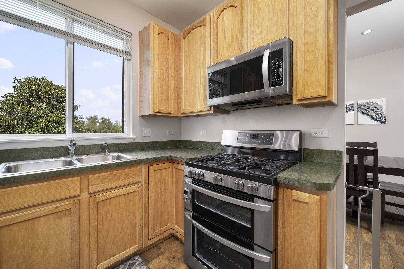 3815 Cherry Tree Lane Joliet, IL 60435 - Photo 12 of 37 a kitchen with stainless steel appliances granite countertop a stove microwave and sink