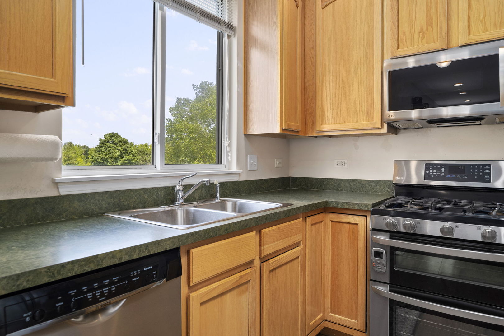 3815 Cherry Tree Lane Joliet, IL 60435 - Photo 13 of 37 a kitchen with stainless steel appliances granite countertop a sink a stove and a microwave