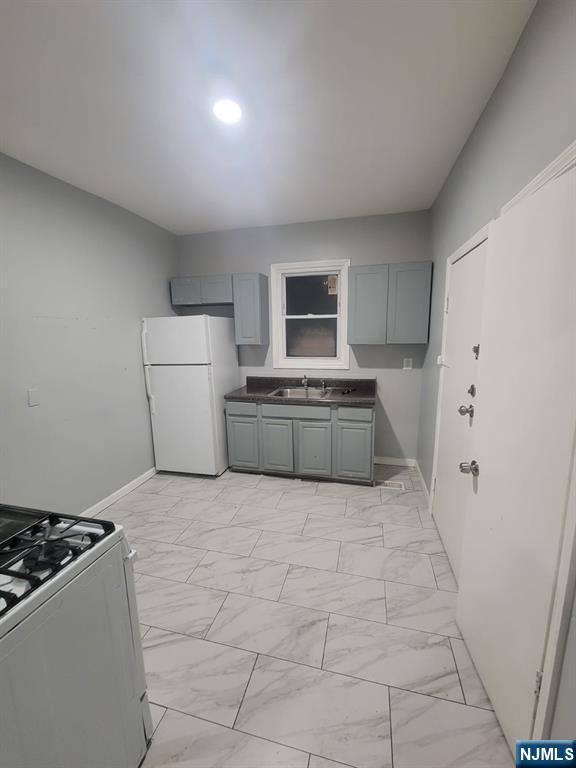 2 Montrose Terrace, Unit 1M Irvington, NJ 07111 - Photo 13 of 13 a large kitchen with a stove and a refrigerator