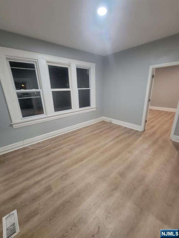 2 Montrose Terrace, Unit 1M Irvington, NJ 07111 - Photo 7 of 13 a view of an empty room with wooden floor and windows