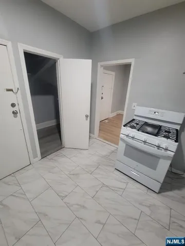 a bedroom with a bed and a stove top oven