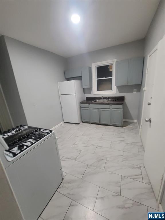 2 Montrose Terrace, Unit 1M Irvington, NJ 07111 - Photo 9 of 13 a bedroom with a bed and a stove top oven