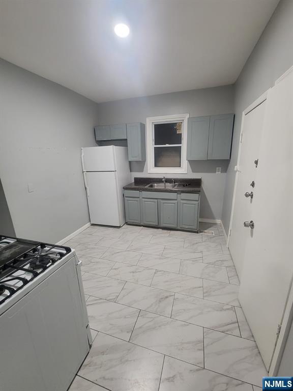 2 Montrose Terrace, Unit 1M Irvington, NJ 07111 - Photo 10 of 13 a large kitchen with a stove and a refrigerator