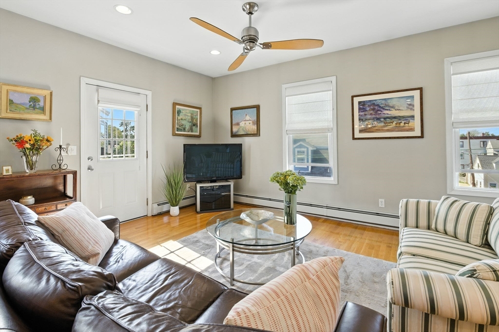 131 Derby Street, Unit 3F Salem, MA 01970 - Photo 15 of 37 a living room with furniture a flat screen tv and a window