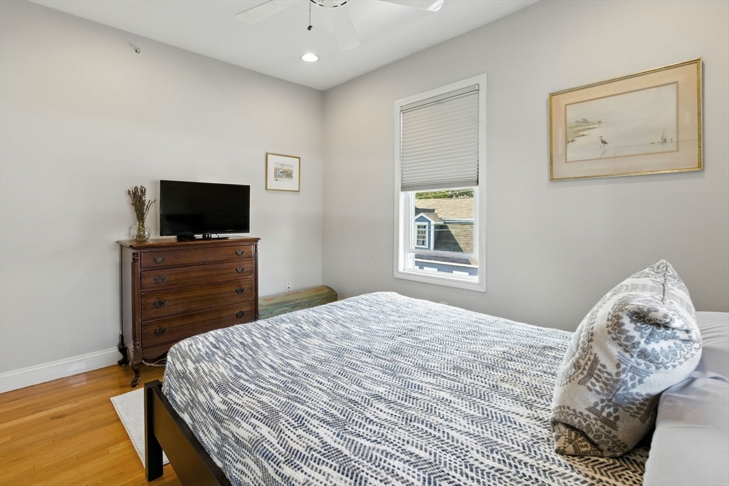 131 Derby Street, Unit 3F Salem, MA 01970 - Photo 22 of 37 a bedroom with a bed and a flat screen tv