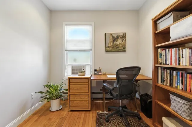 a living room with furniture and a book shelf