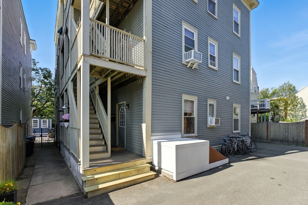 131 Derby Street, Unit 3F Salem, MA 01970 - Photo 30 of 37 a view of a patio with a table and chairs and potted plants