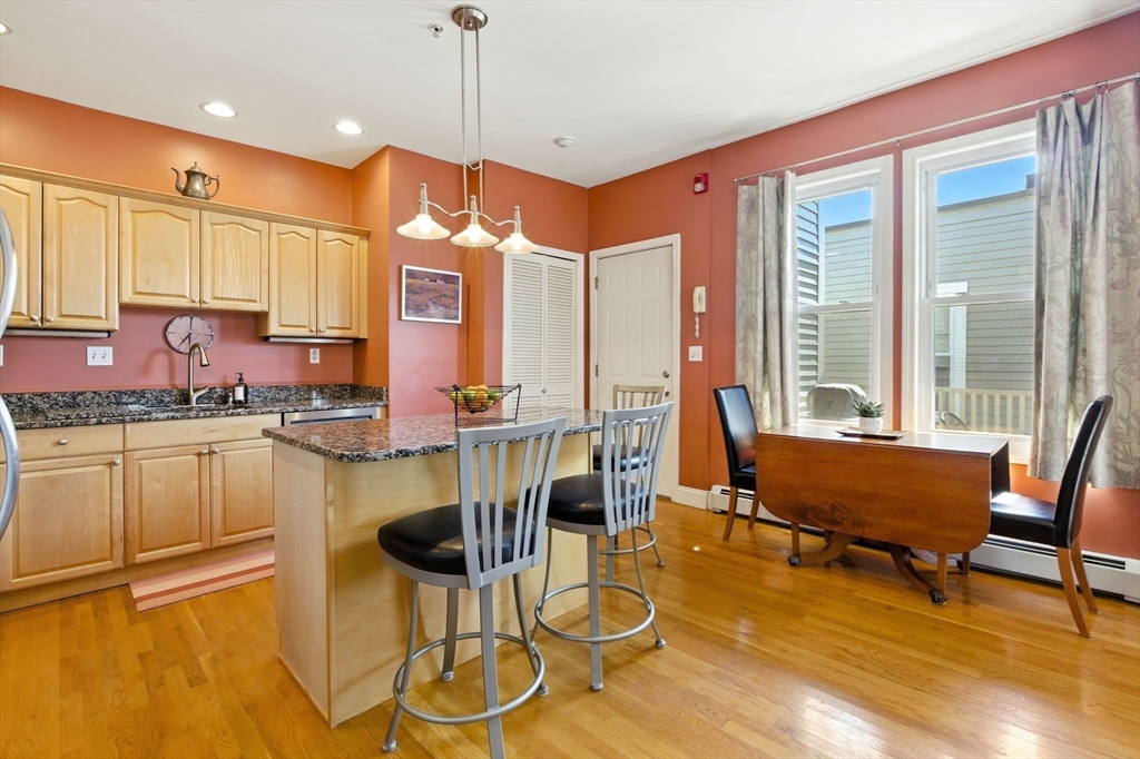 131 Derby Street, Unit 3F Salem, MA 01970 - Photo 10 of 37 a view of a dining room with furniture a chandelier and wooden floor