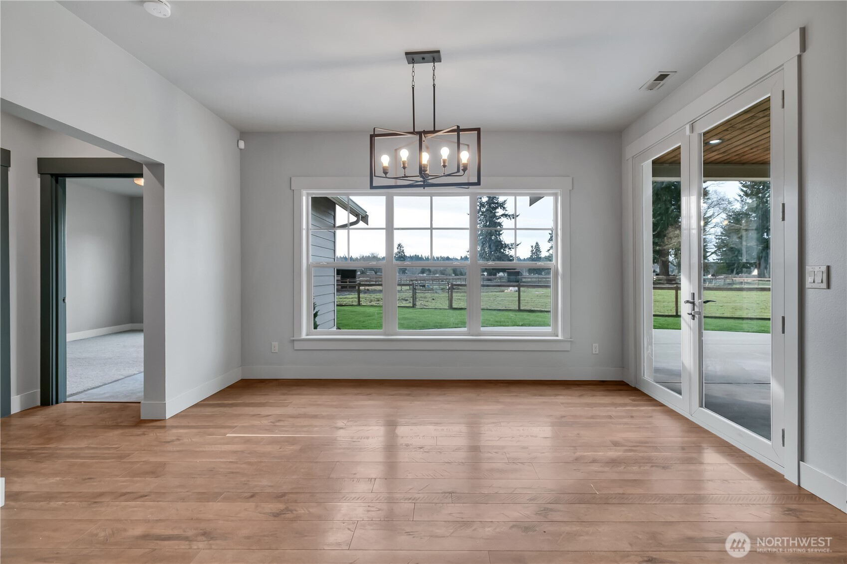 8106 Spurgeon Creek Road Southeast Olympia, WA 98513 - Photo 11 of 29 a view of empty room with wooden floor and fan