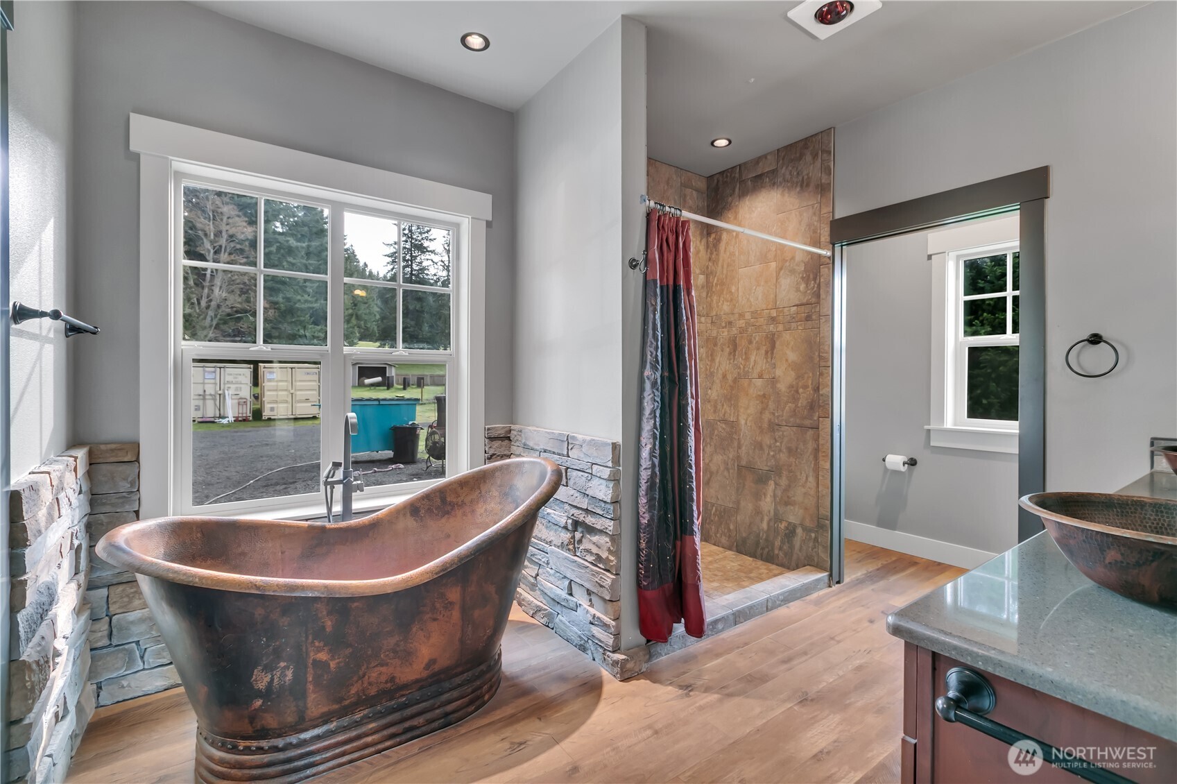 8106 Spurgeon Creek Road Southeast Olympia, WA 98513 - Photo 15 of 29 a living room with large glass windows and a table