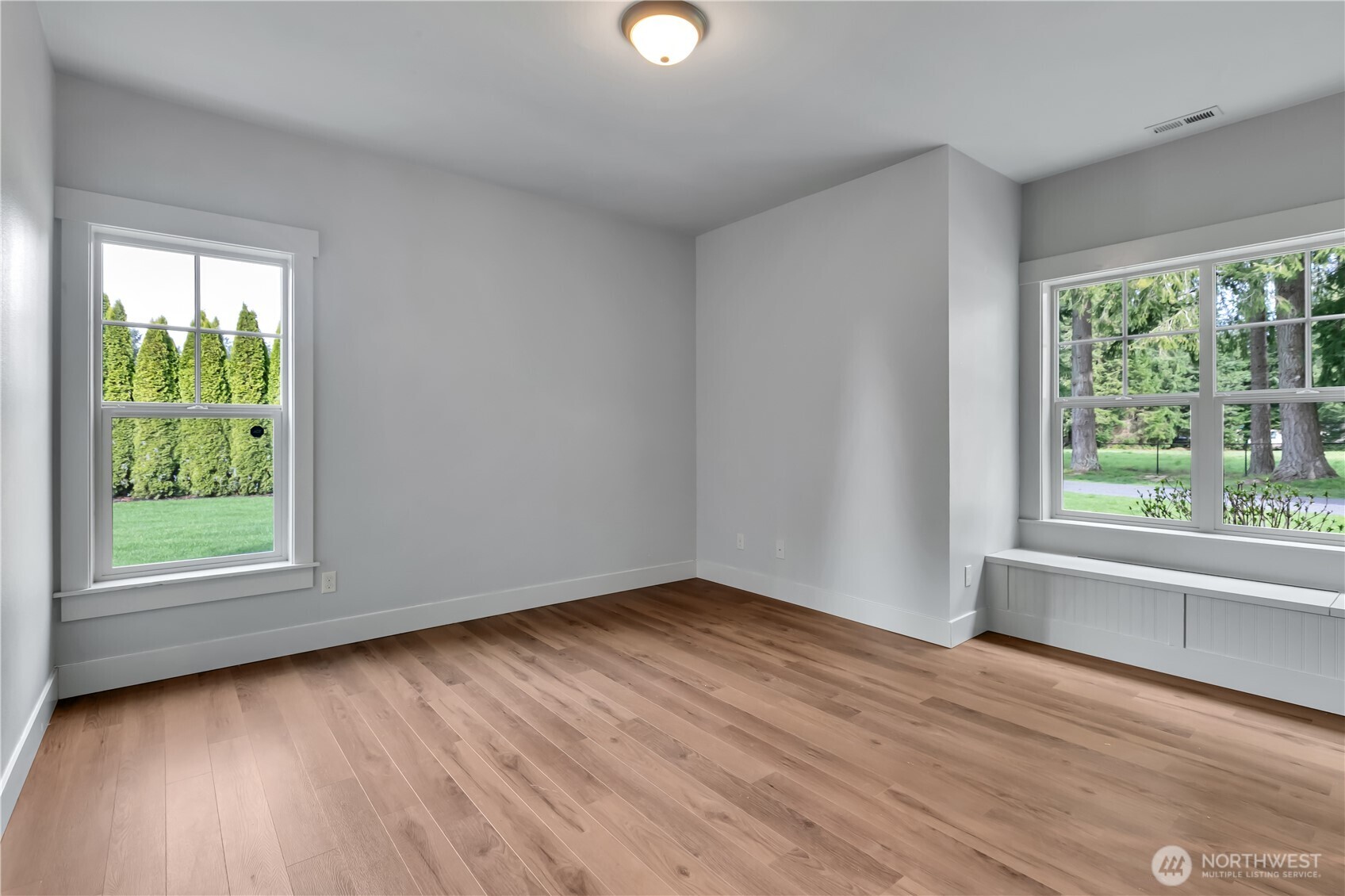 8106 Spurgeon Creek Road Southeast Olympia, WA 98513 - Photo 17 of 29 a view of an empty room with wooden floor and a window