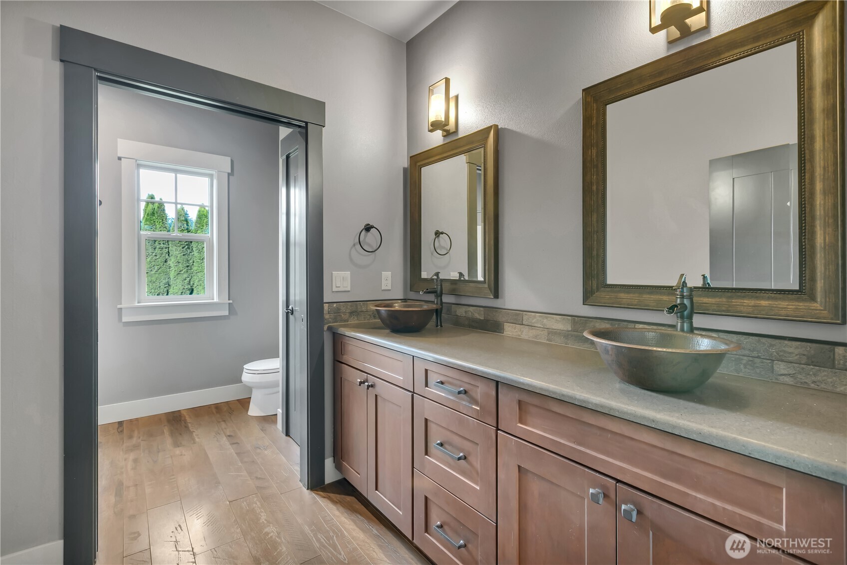 8106 Spurgeon Creek Road Southeast Olympia, WA 98513 - Photo 18 of 29 a bathroom with a granite countertop sink a toilet and a mirror