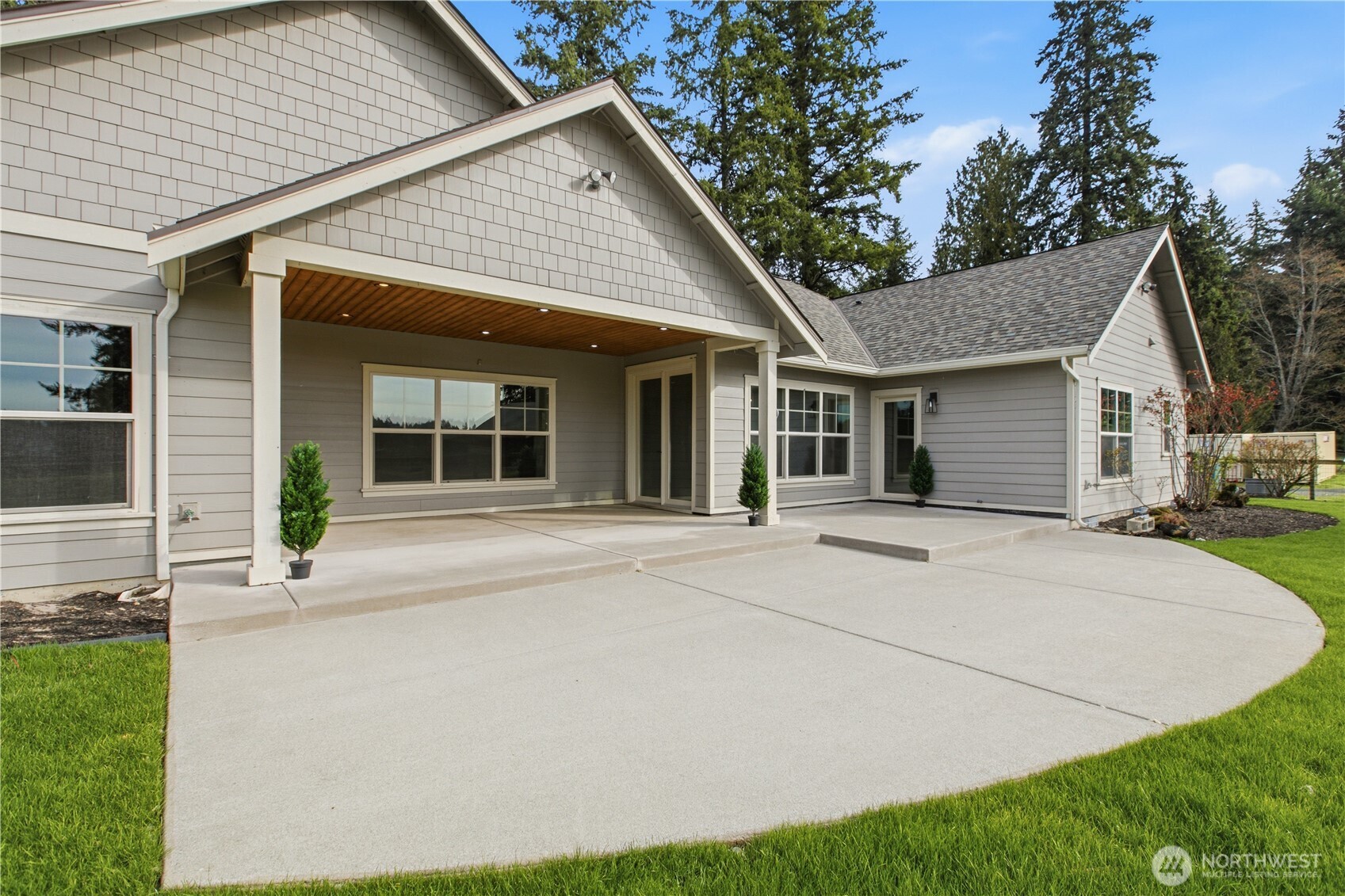 8106 Spurgeon Creek Road Southeast Olympia, WA 98513 - Photo 20 of 29 a front view of a house with a yard and potted plants