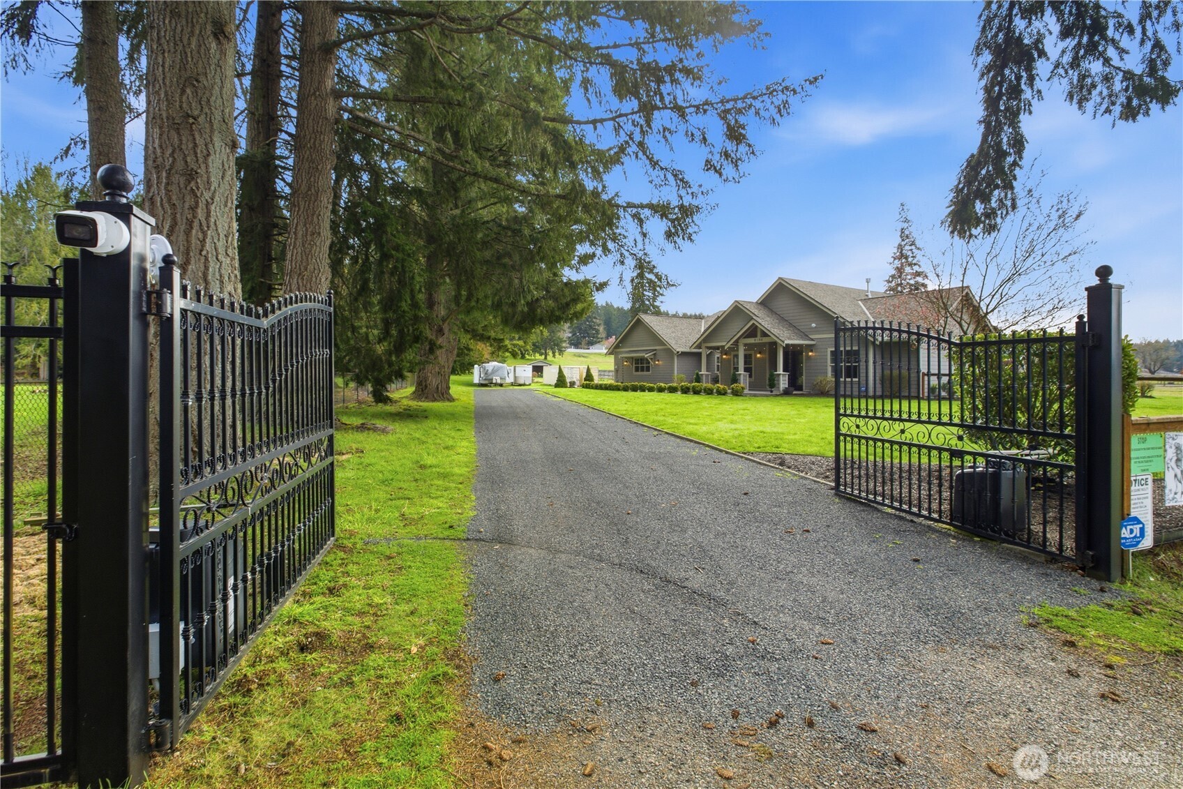 8106 Spurgeon Creek Road Southeast Olympia, WA 98513 - Photo 3 of 29 a view of a house with wooden fence next to a yard