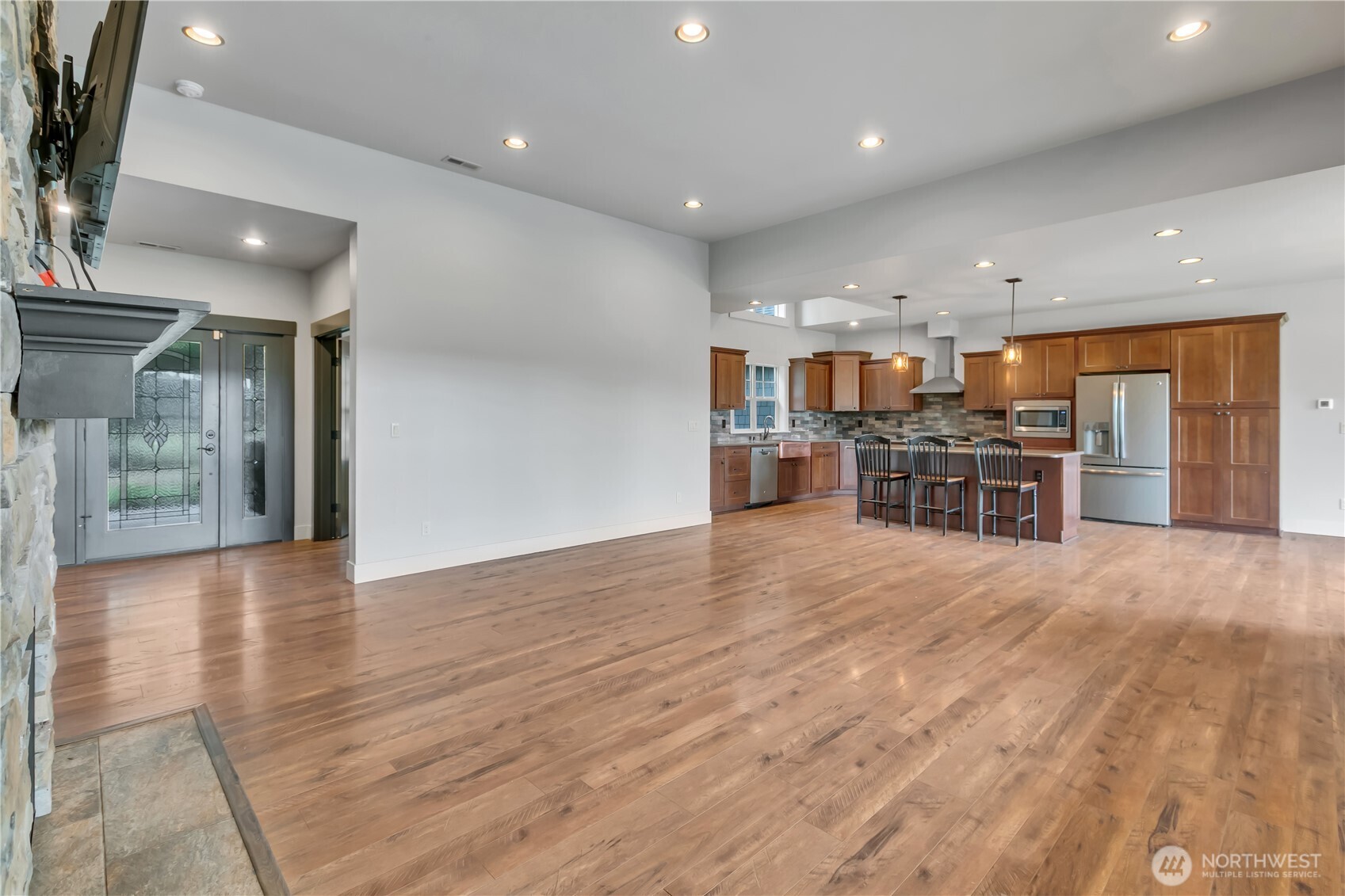 8106 Spurgeon Creek Road Southeast Olympia, WA 98513 - Photo 7 of 29 a view of a kitchen with cabinets and wooden floor