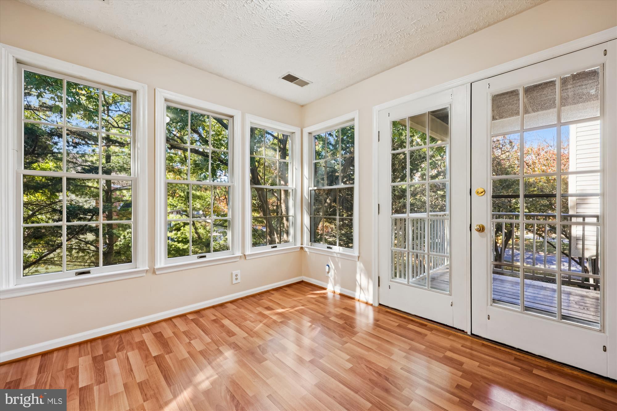 13114 Briarcliff Terrace, Unit 407 Germantown, MD 20874 - Photo 13 of 77 a view of an empty room with wooden floor and a window
