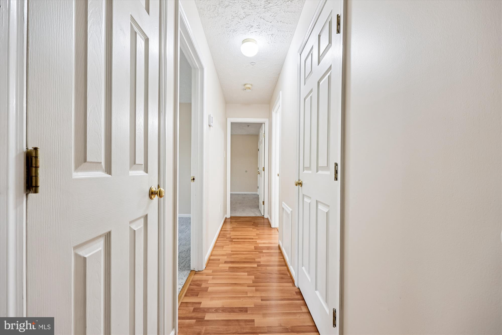 13114 Briarcliff Terrace, Unit 407 Germantown, MD 20874 - Photo 34 of 77 a view of a hallway with wooden floor and staircase