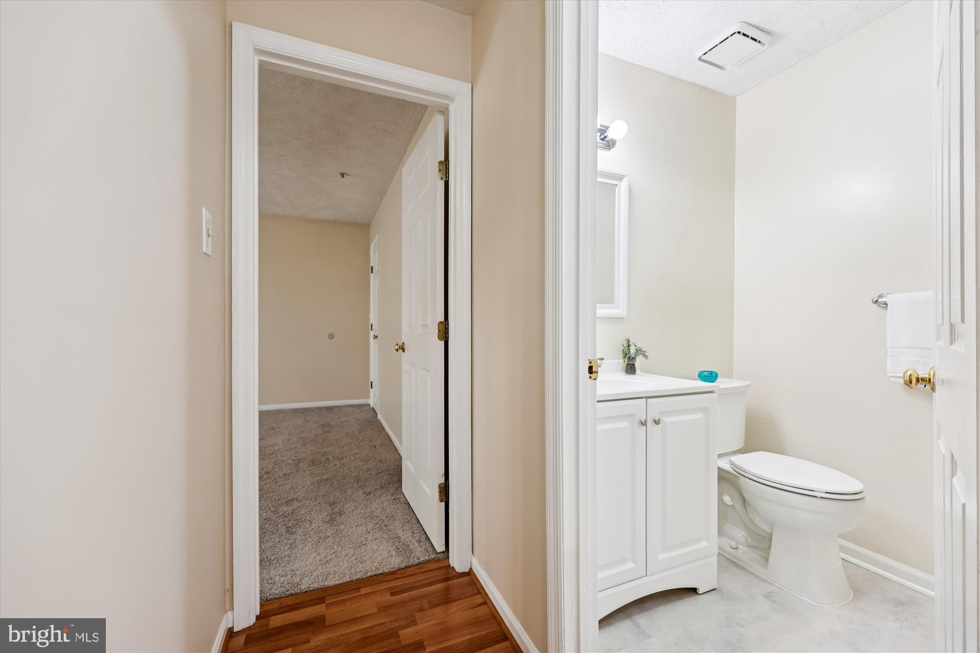13114 Briarcliff Terrace, Unit 407 Germantown, MD 20874 - Photo 35 of 77 a bathroom with a granite countertop toilet a sink and a mirror