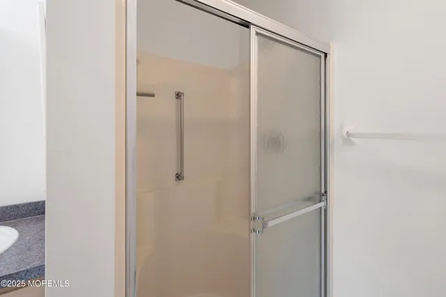 a bathroom with a glass shower door