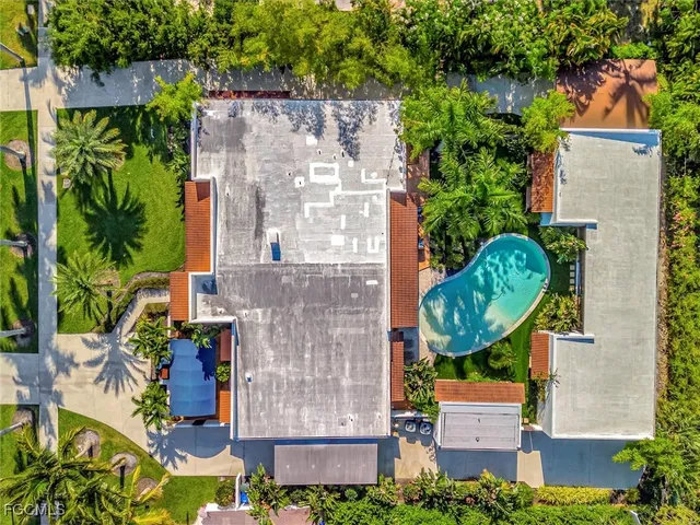 an aerial view of a house with garden space and street view