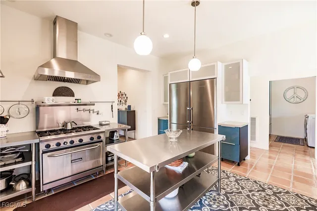 a kitchen with stainless steel appliances a stove a sink and cabinets