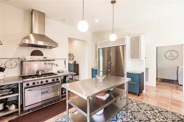 a kitchen with stainless steel appliances a stove a sink and cabinets
