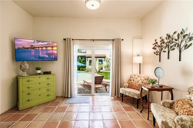 a living room with furniture and a painting on the wall
